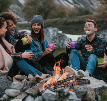 Bunch Of People Enjoying Company Surrounded By Lush Green Mountain